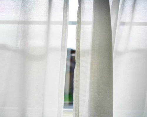 Soft sunlight filtering through translucent curtains in a living room